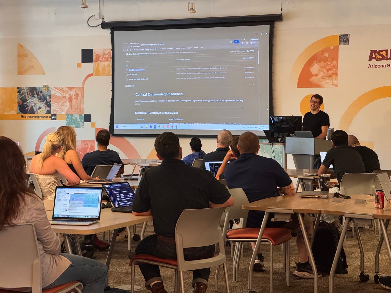 A full room of attendees working through an AI workshop